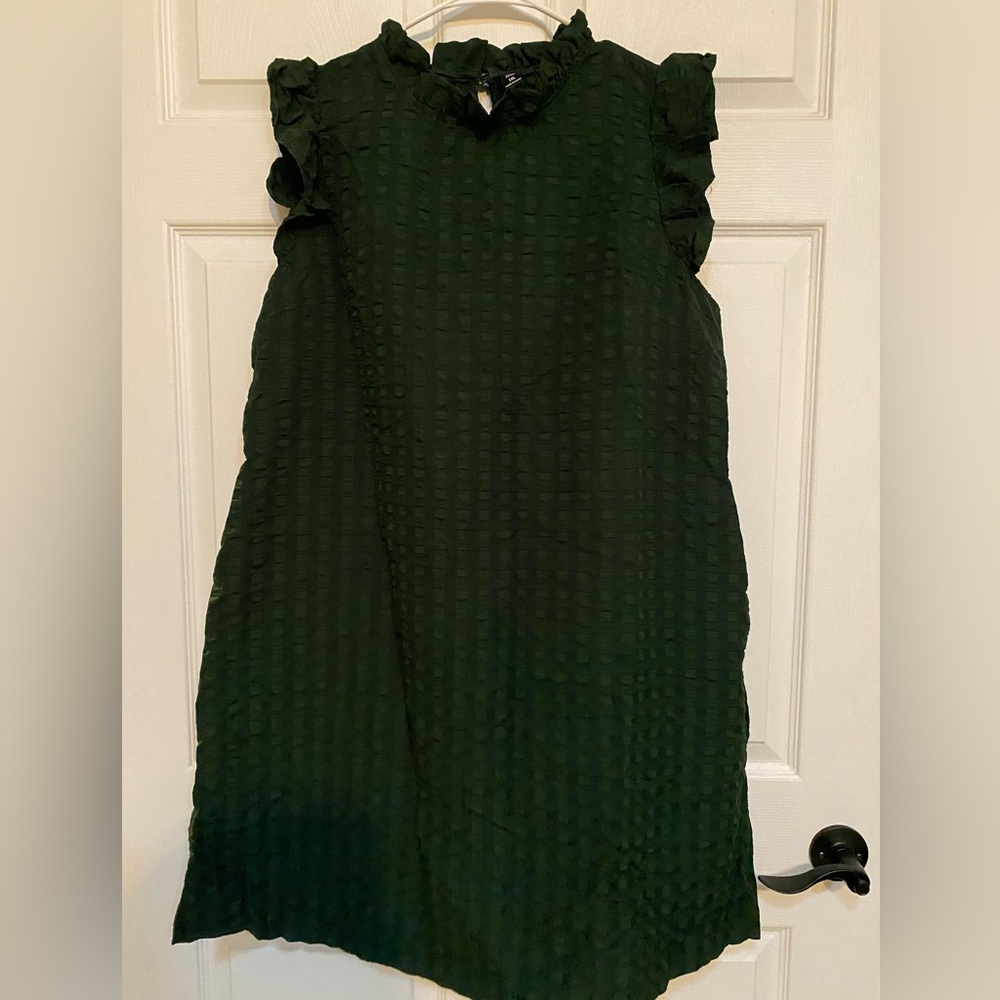 NWOT. Dark green dress with ruffled neck and shoulders.